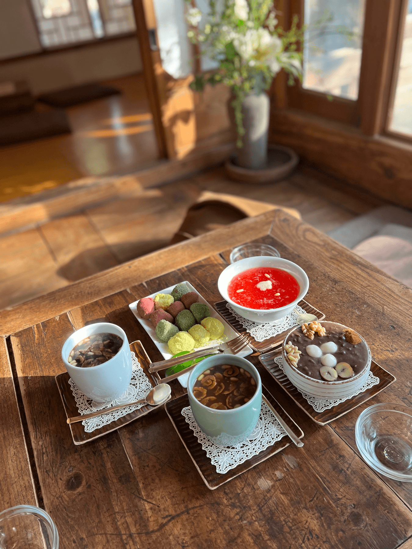 Colorful Korean rice cakes and traditional desserts on a wooden table