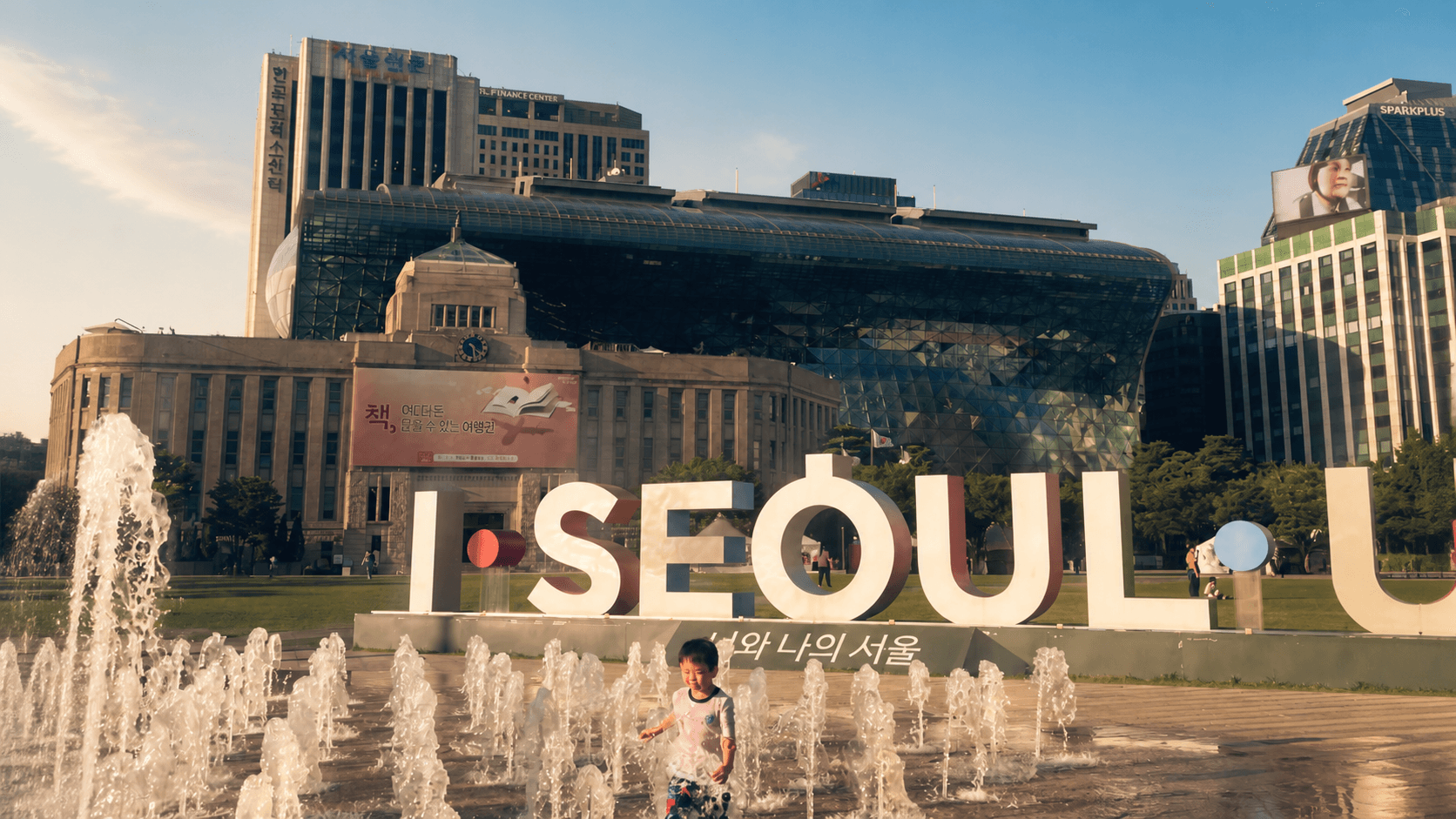 Seoul City Hall plaza and the city skyline in warm afternoon light